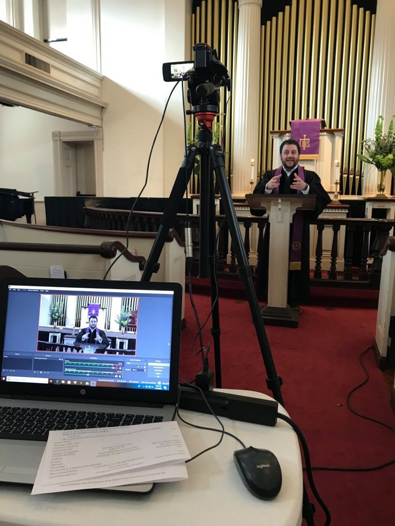 The Rev. Ben Gosden (in background) leads virtual worship using the equipment in the foreground. (Courtesy Photo).